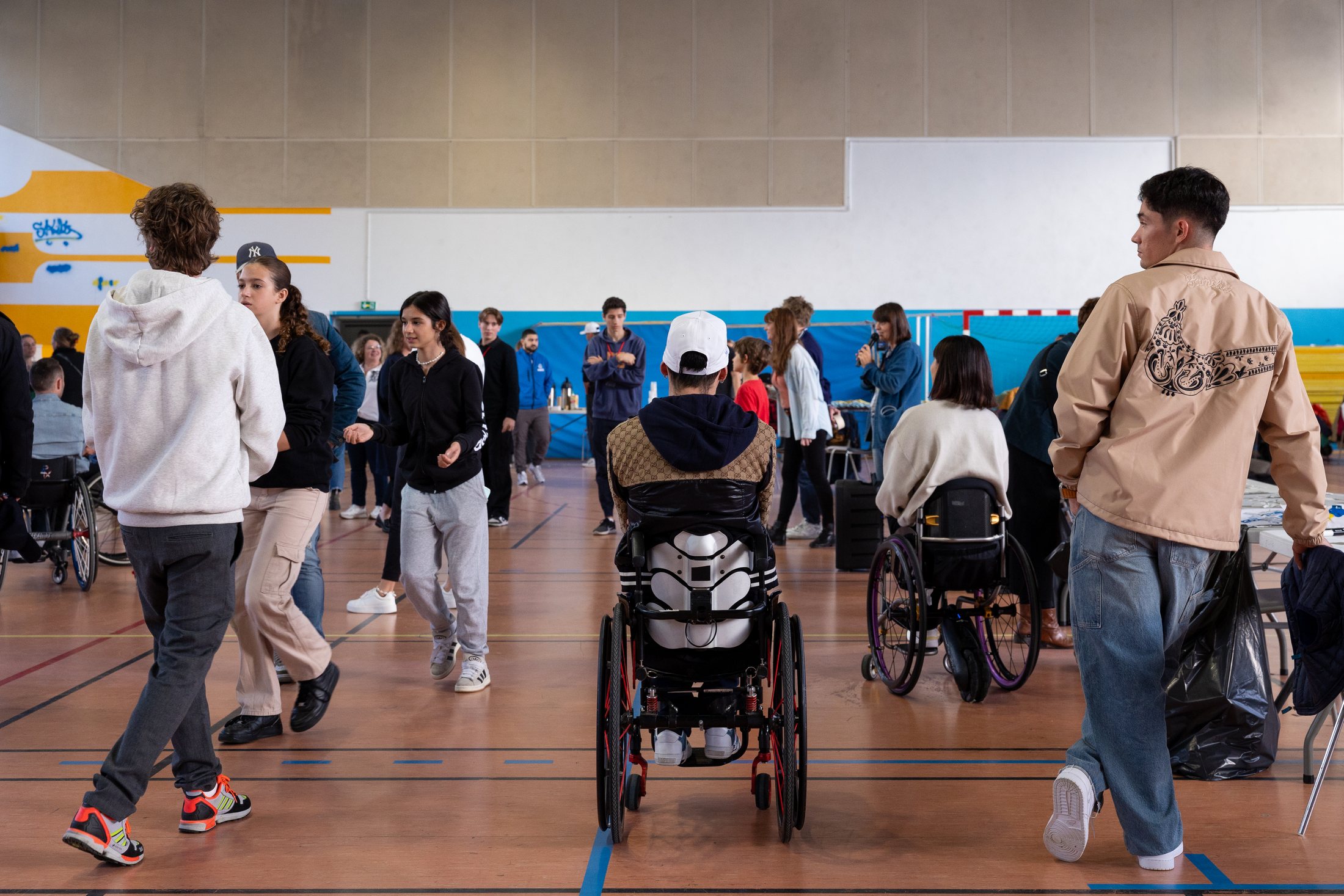 Team Visa athletes and guests moving through an accessible creative studio in Paris
