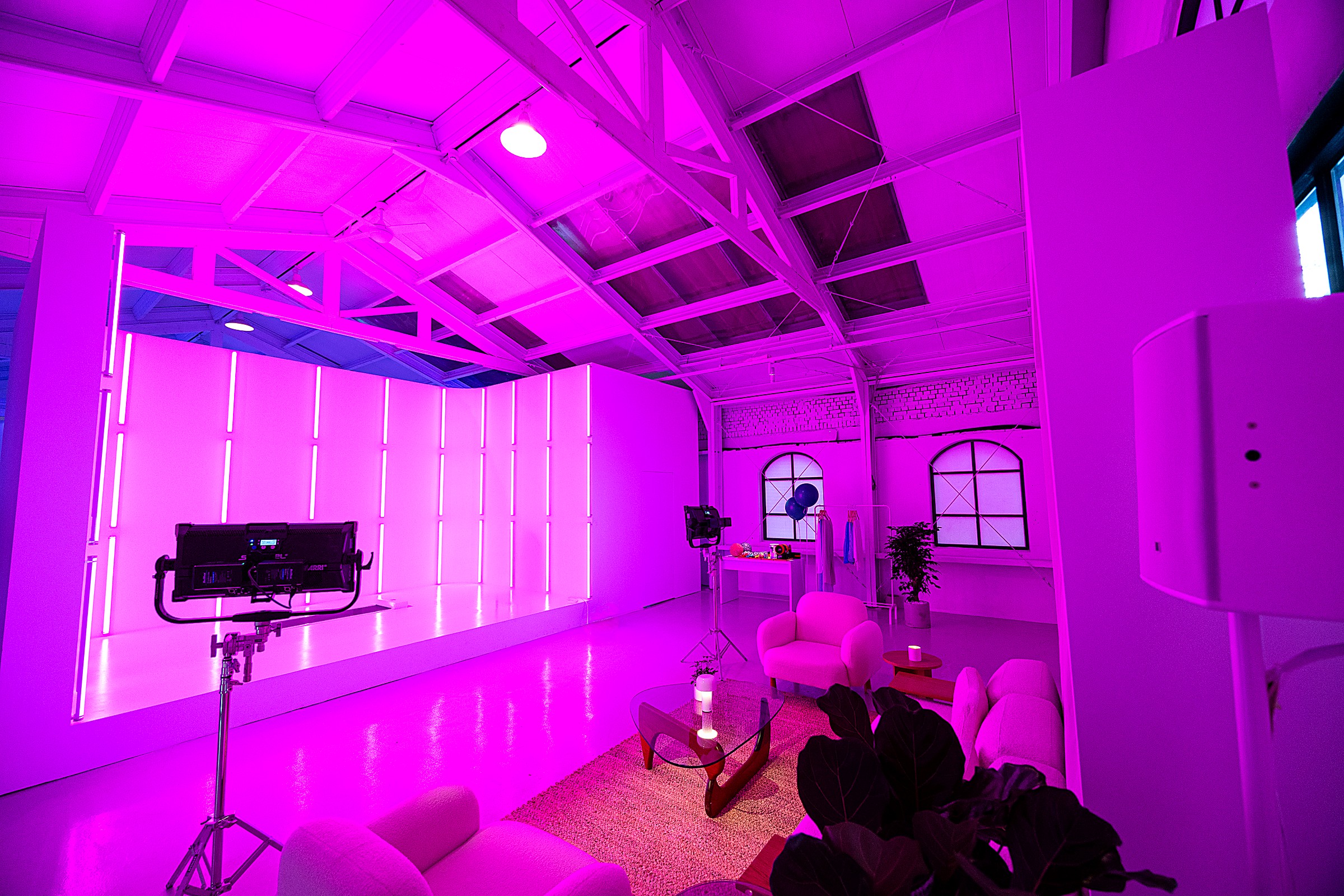 Lit studio wall and lounge set, dressed for content capture
