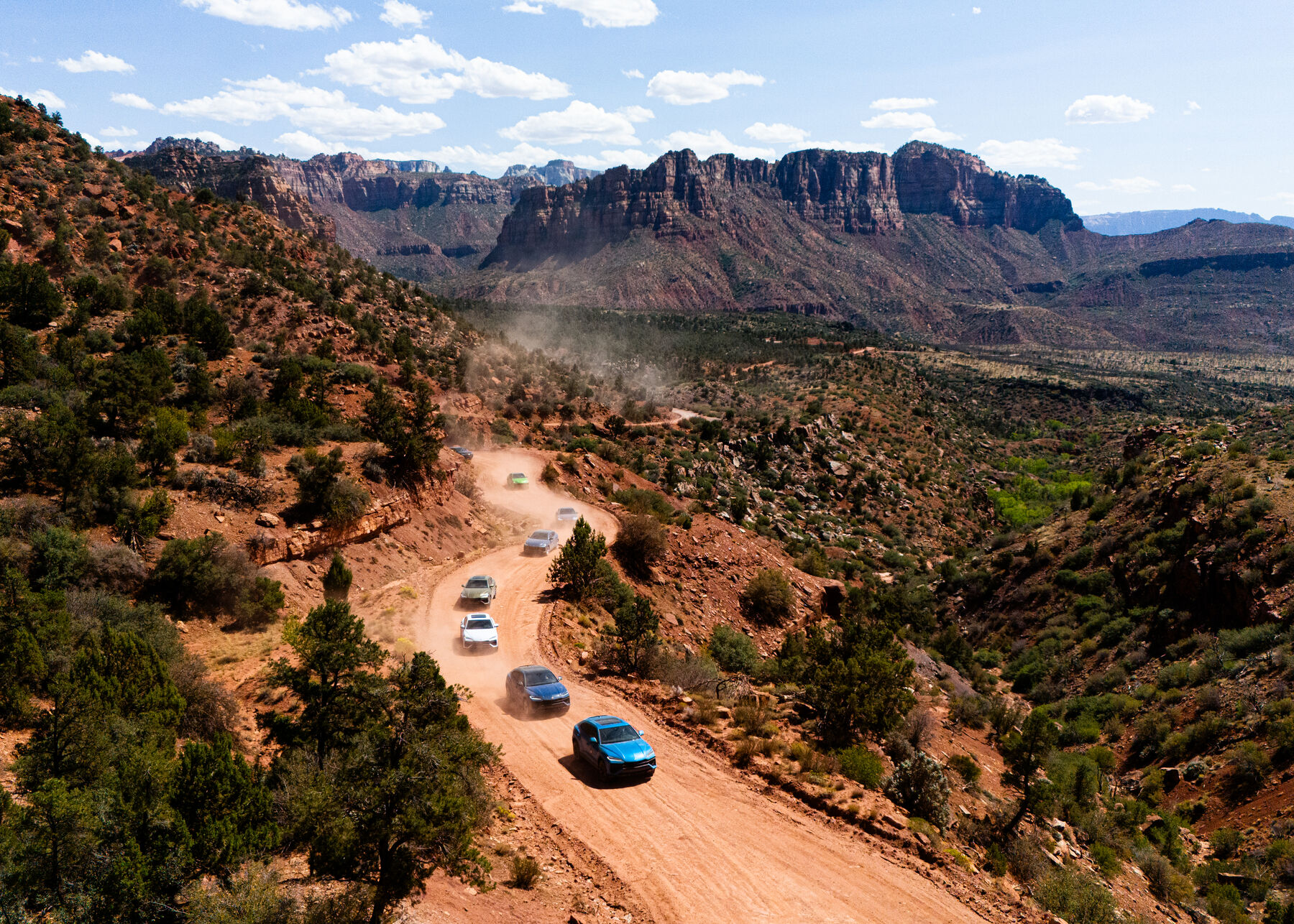 The Urus convoy on a dirt road above the red rock canyons of Southern Utah