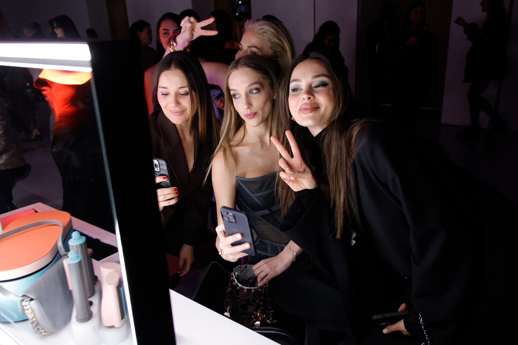 Guests at a lit styling station during the launch