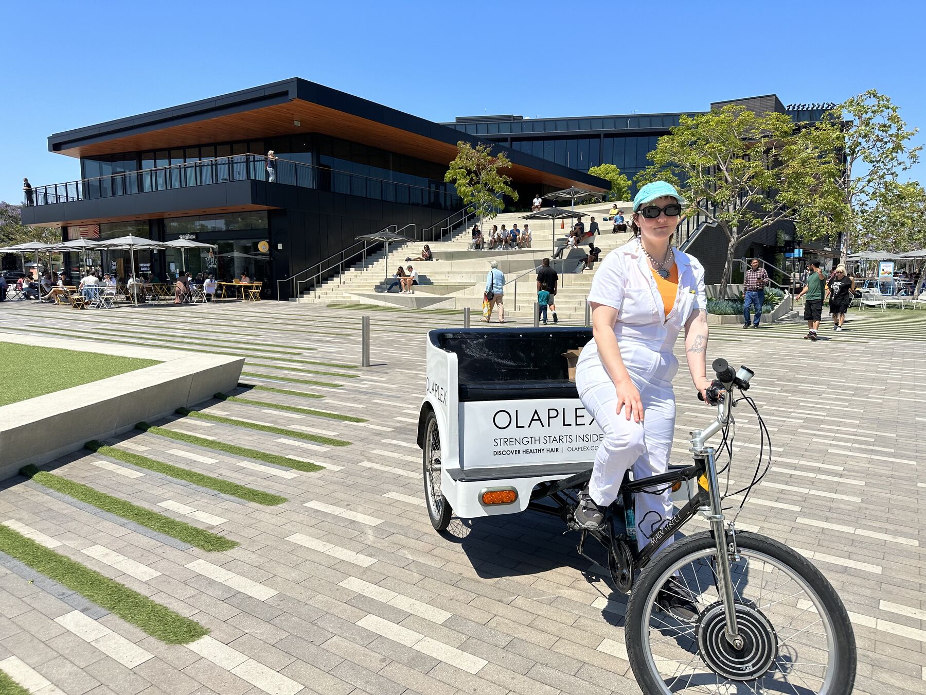 A branded sampling pedicab on a plaza during hand-outs