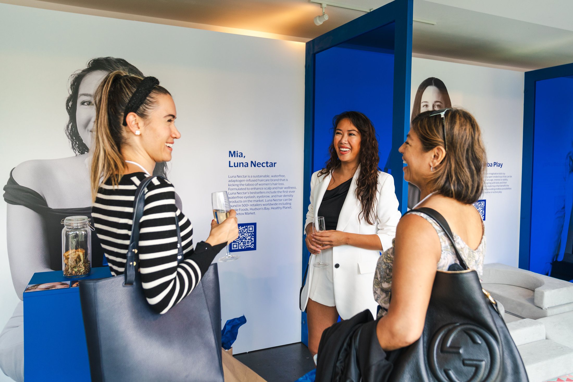 Guests meeting beside founder portraits at Visa She's Next