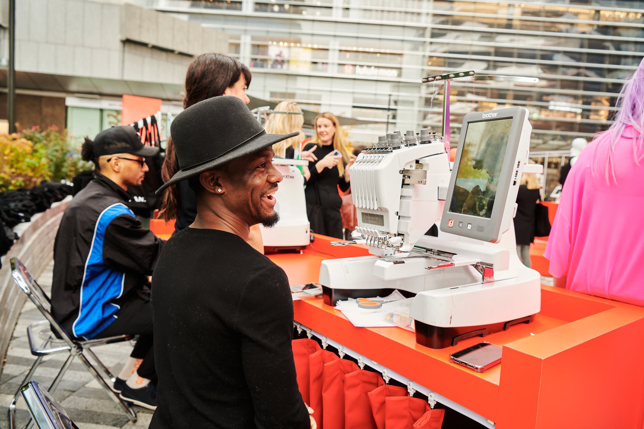 Guests using a customization station at the pop-up