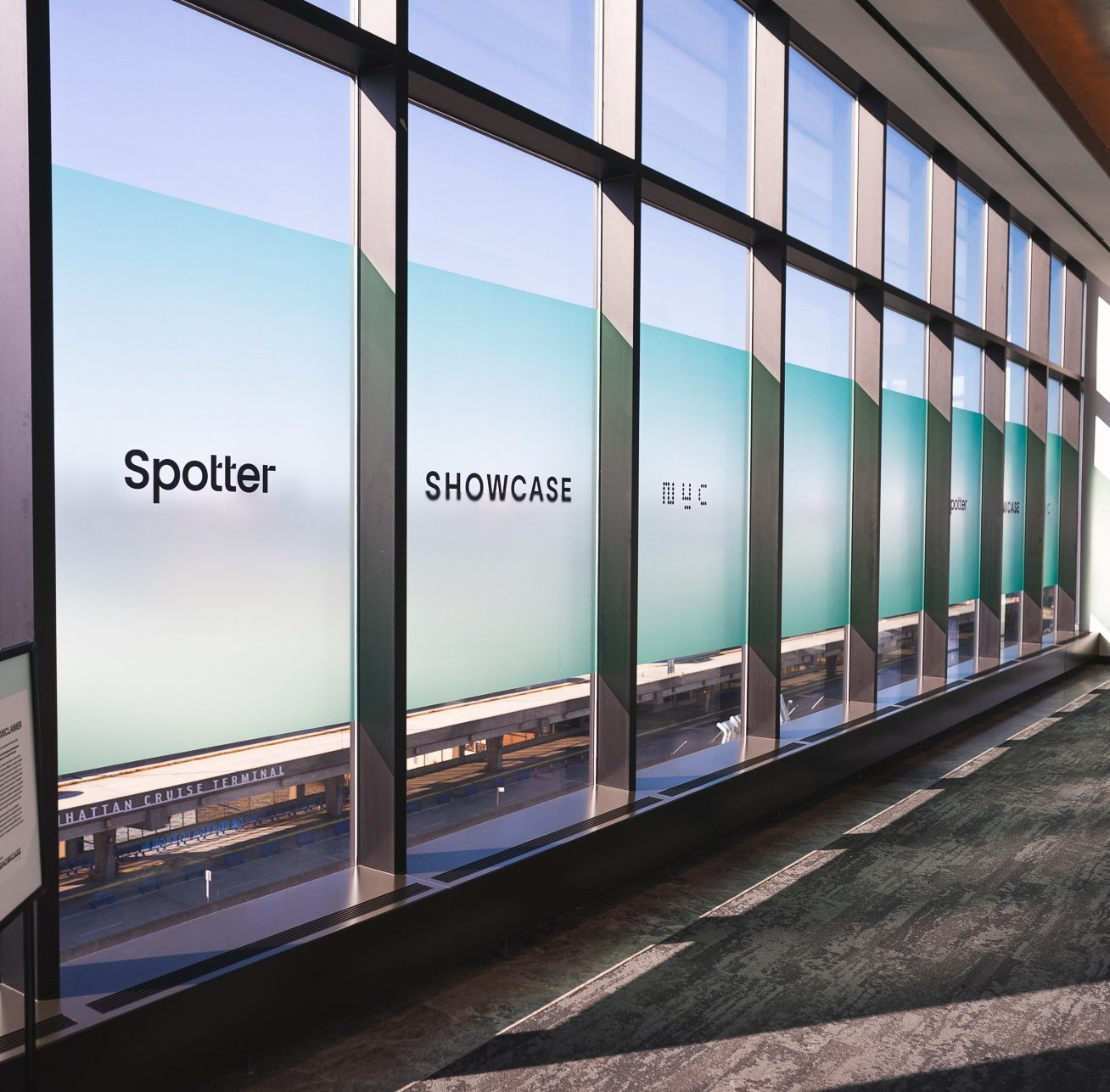 Spotter Showcase window graphics along the venue concourse