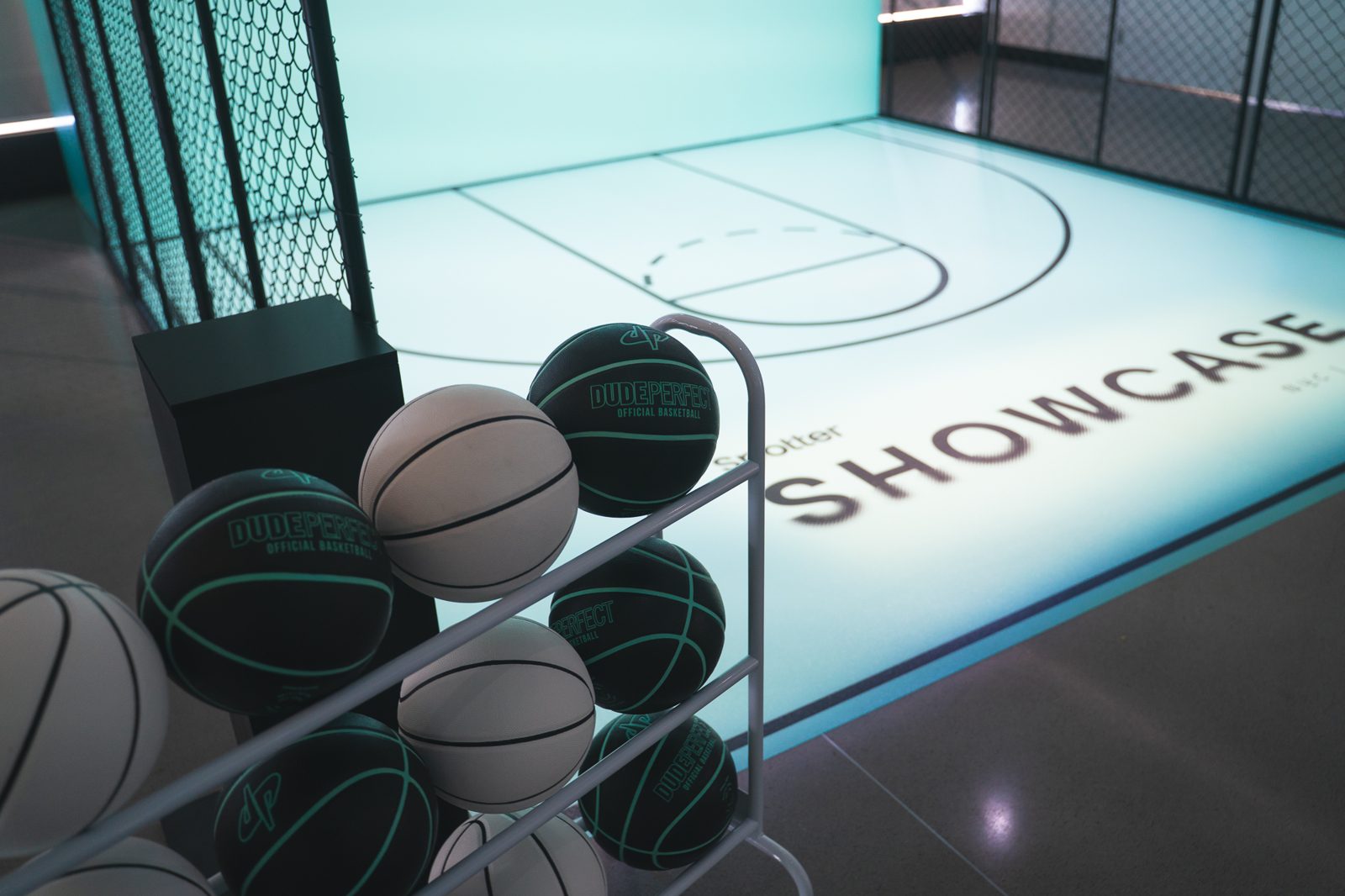 Dude Perfect branded basketballs beside the court activation